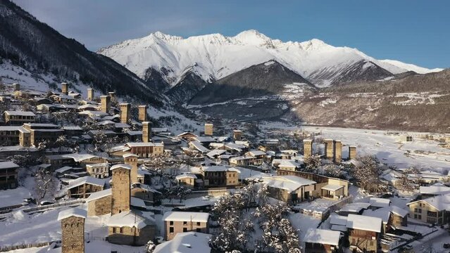 Small town in winter in a stunning mountain valley aerial view, done video. Mestia Svaneti Georgia