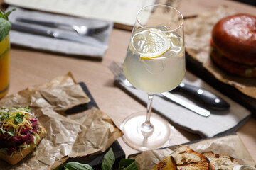 Sour lemon cocktail in a high glass. Refreshing citrus long drink with alcohol served in a restaurant for dinner