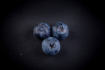 Blueberries on stone plate background