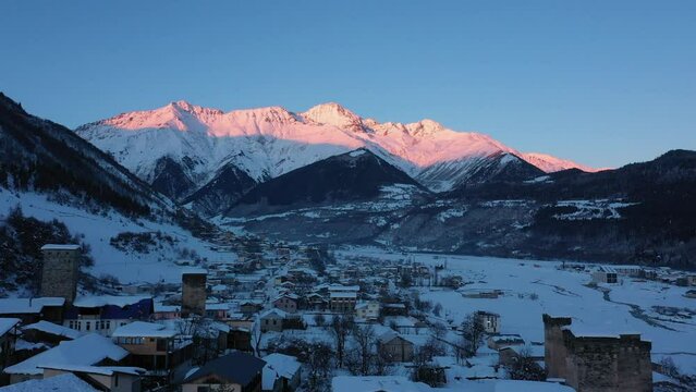 Small town in winter in a stunning mountain valley aerial view, done video. Mestia Svaneti Georgia