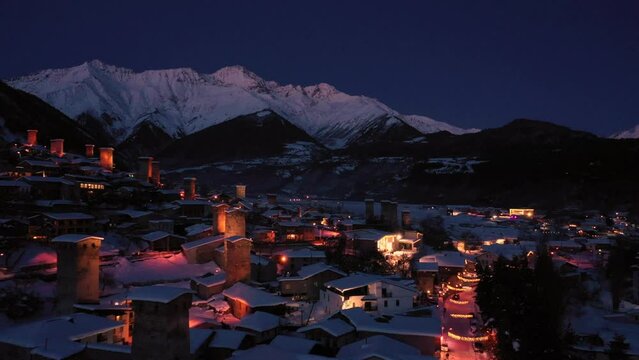 Mountain small town in winter at night aerial drone  view. Mestia Svaneti, Georgia