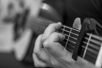 male hands playing acoustic guitar, close up.Acoustic guitar with a beautiful wood .