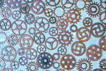 Lot of metal gears gray background.