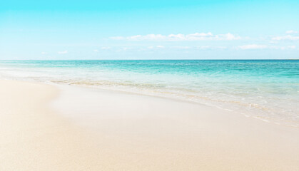 Fototapeta na wymiar Summer Beach Background - Clear turquoise blue water on white sandy beach - Morrojable, Fuerteventura, Spain