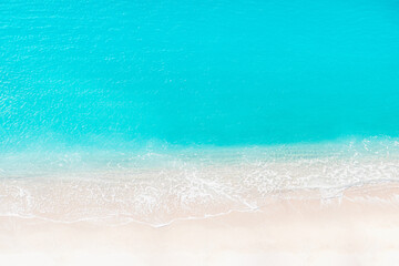 Fototapeta na wymiar Beach Summer Background - Aerial view of waves on white sand and turquoise sea water - Copy space