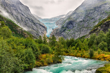 bricksdalbreen glacier with an ice waterfall and the river from melted ice