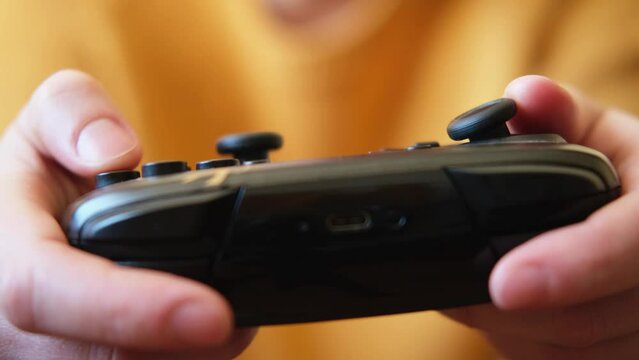 Woman hands holding black joystick gamepad playing game console. Computer gaming competition videogame control concept. Using controller playing video games. Cyberspace symbol. Hands joypad close up