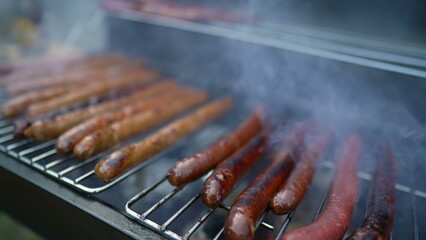 Cooking sausages on barbecue Grill. Grilling Hot dogs BBQ