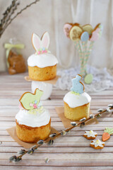 Easter cakes with decor and a willow branch on the table, pastel colors