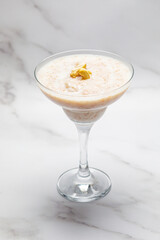 oatmeal served in a glass goblet on a marbled background