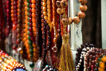 Rosaries lined up on the counter of a rosary seller in Istanbul.