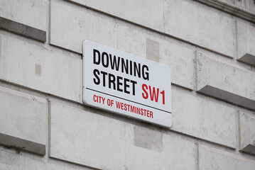 Downing Street sign on the wall of a building in Westminster, London, UK. 