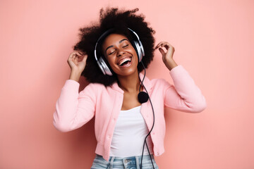 Beautiful black woman with afro hair and headphones laughing and listening to music looking at the camera on pink background, Generative AI
