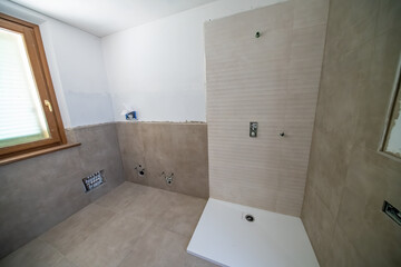 Bathroom after renovation. New stone tiles on the bath room floor.  Home renovation and improvement concept