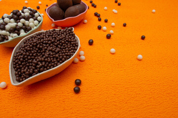 baskets of chocolate balls on an orange background