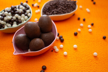 baskets of chocolate balls on an orange background