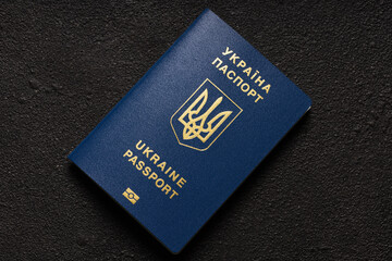 Ukrainian blue foreign biometric passport with a chip on a black textured background. Ukraine