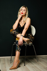 Beautiful blonde woman sitting on a chair