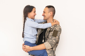 pretty little girl hugging her military father.