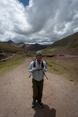 Hiker in the high elevation region of Rainbow Mountain region of Cusco, Peru