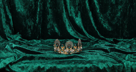 crown with emeralds on green velvet