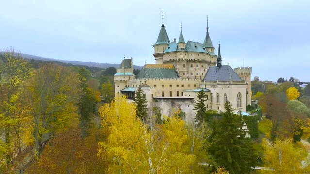 Fairytale, romantic castle Bojnice in Slovakia, popular as a backdrop for fantasy and fairytale films. An aerial view of the castle and garden in autumn colours. Portals, residential towers. Slovakia.
