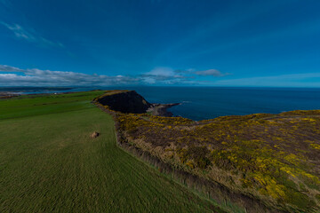 Drone panorama of cliffs and hexagonal stones or pillars at Giants causeway in northern ireland,...