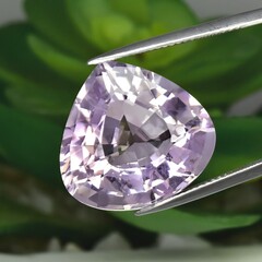 Natural gemstone purple amethyst on gray background