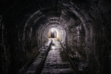 Vaulted tunnel with concrete walls in old abandoned bunker, mine, drainage, subway, etc