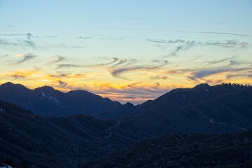 The sun sets and dusk falls on the Angeles Crest Highway, a winding route through the San Gabriel Mountains and Angeles National Forest just north of Los Angeles