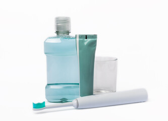 Mouthwash, toothpaste and electric toothbrush isolated on white background.Mouthwash and other dental care items on white background.Prevention of caries and plaque. Gum and mouth care. Fresh breath.