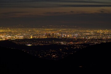 Dusk falls on Los Angeles far below us, from the Angeles Crest Highway in the San Gabriel Mountains
