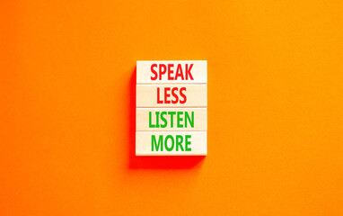 Speak less listen more symbol. Concept words Speak less listen more on wooden block. Beautiful orange table orange background. Motivational business speak less listen more concept. Copy space.