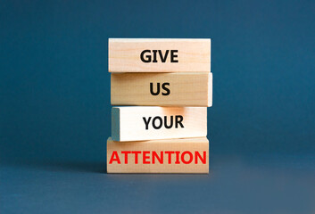 Give us your attention symbol. Concept words Give us your attention on wooden block. Beautiful grey table grey background. Motivational business give us your attention concept. Copy space.