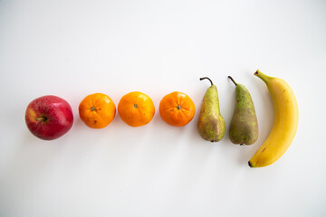 top view of different fruits on white background