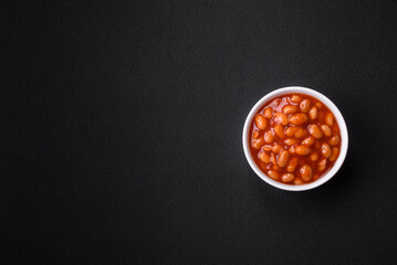 Delicious canned beans in a tomato in a white ceramic bowl