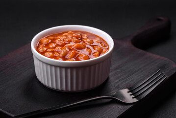 Delicious canned beans in a tomato in a white ceramic bowl