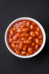 Delicious canned beans in a tomato in a white ceramic bowl