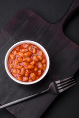 Delicious canned beans in a tomato in a white ceramic bowl