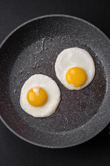 Delicious nutritious English breakfast with fried eggs and tomatoes