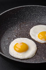 Delicious nutritious English breakfast with fried eggs and tomatoes