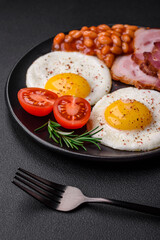 Delicious nutritious English breakfast with fried eggs and tomatoes