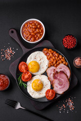 Delicious nutritious English breakfast with fried eggs and tomatoes