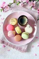 Colorful macaroons on the plate with coffee. Top view. French dessert.