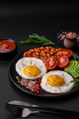 Delicious nutritious English breakfast with fried eggs, tomatoes and avocado