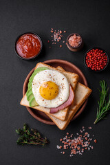 Delicious nutritious English breakfast with fried eggs, tomatoes and avocado