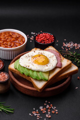 Delicious nutritious English breakfast with fried eggs, tomatoes and avocado