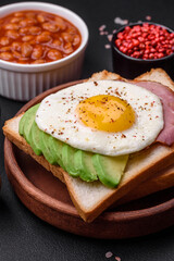 Delicious nutritious English breakfast with fried eggs, tomatoes and avocado