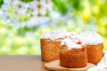 Easter holiday food concept. Homemade Easter cake with white icing, jelly candies, sweet powder, marsmallow, decorated on wooden background with copy space