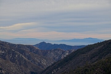 The winding Angeles Crest Highway provides views over the Los Angeles Basin and surrounding urban valleys, the snow-dusted San Gabriel and San Bernandino Mountains and the Mojave Desert
